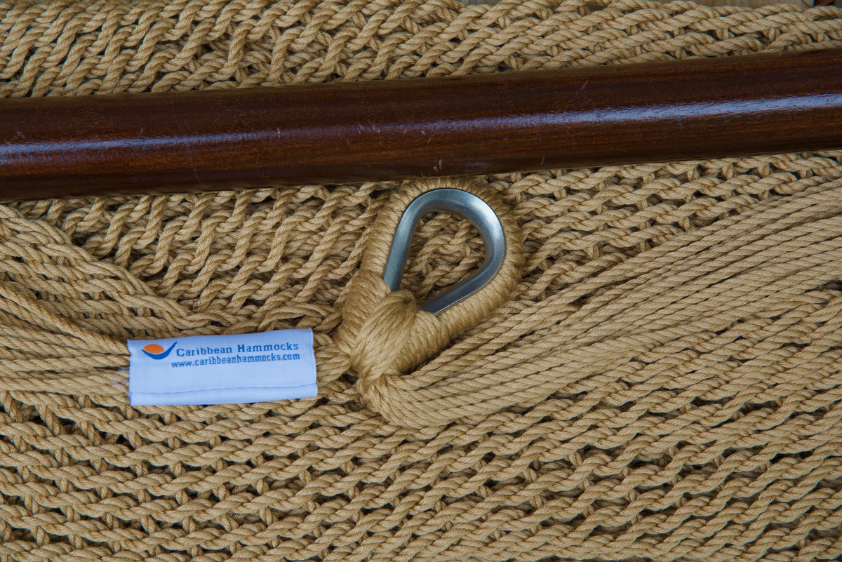Close-up of the sewn brand label and zinc-plated ring at the seat edge of a tan Island Haven hammock chair