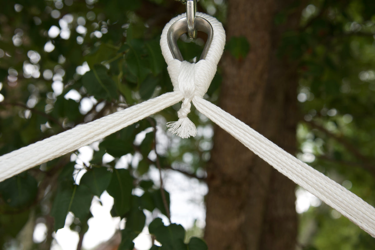 Close-up of the zinc-plated hanging ring where the white end cords of an Island Haven hammock chair meet