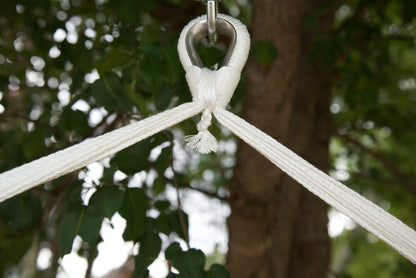 Close-up of the zinc-plated hanging ring where the white end cords of an Island Haven hammock chair meet