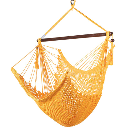Island Haven hammock chair in yellow, hand-woven poly cord with a dark hardwood spreader bar and tasseled ends, on a white background