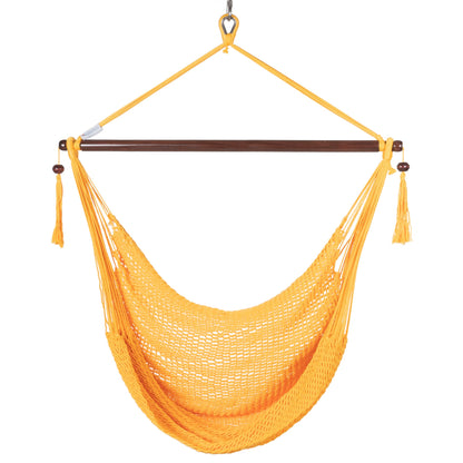 Front view of a yellow Island Haven hammock chair showing the deep open-weave seat and built-in footrest, on a white background