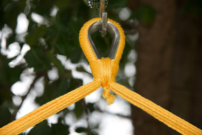 Close-up of the zinc-plated hanging ring where the yellow end cords of an Island Haven hammock chair meet