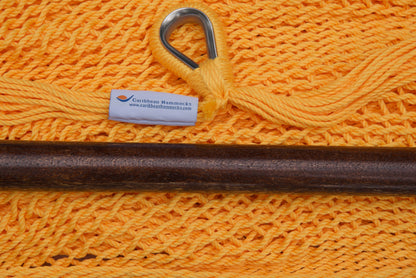 Close-up of the sewn brand label and zinc-plated ring at the seat edge of a yellow Island Haven hammock chair
