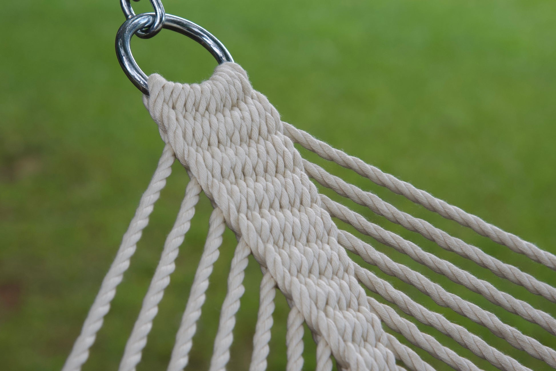 Stainless steel hanging ring, polyester end cords, and clew knot on a cream Island Oasis hammock, lawn behind