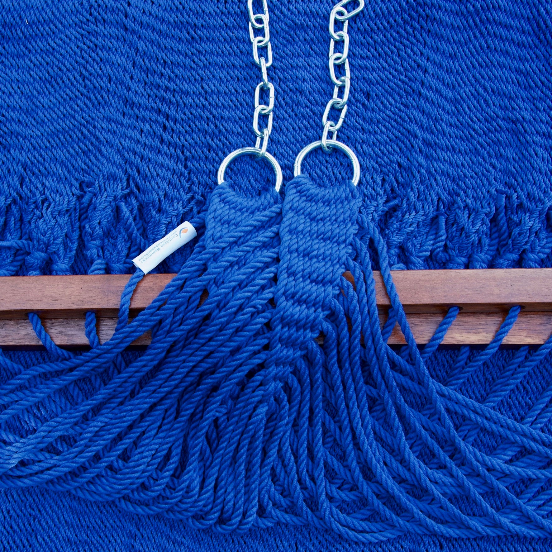 Clew knot on a dark blue Island Oasis hammock, polyester cords gathered into stainless steel rings with hanging chain