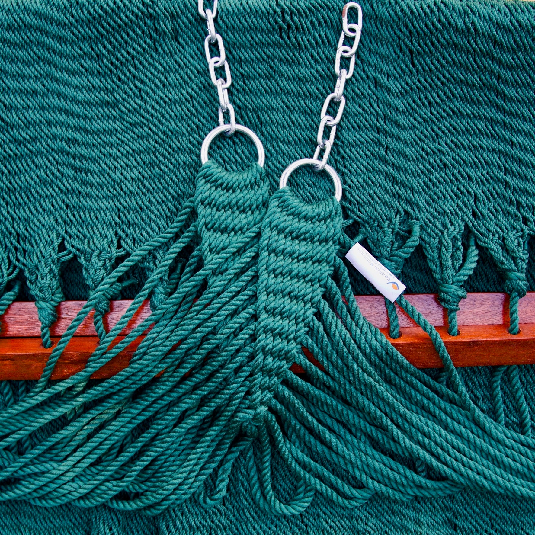 Clew knot on a green Island Oasis hammock, polyester cords gathered into stainless steel rings with hanging chain