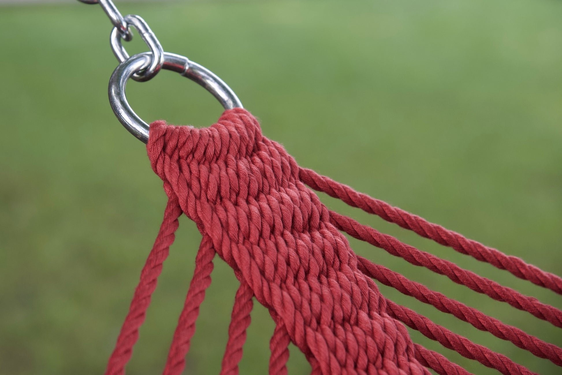 Stainless steel hanging ring, polyester end cords, and clew knot on a red Island Oasis hammock, lawn behind
