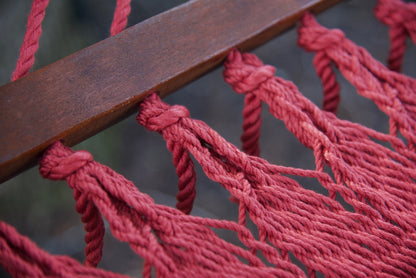 Hardwood spreader bar on a red Island Oasis hammock with knotted polyester cord ends