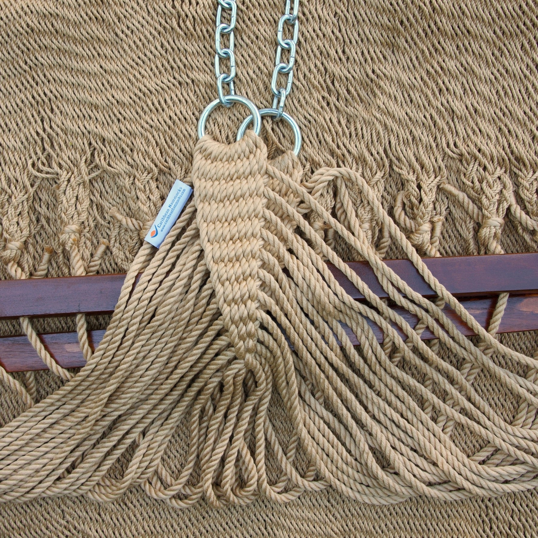 Clew knot on a tan Island Oasis hammock, polyester cords gathered into stainless steel rings with hanging chain and Caribbean Hammocks label