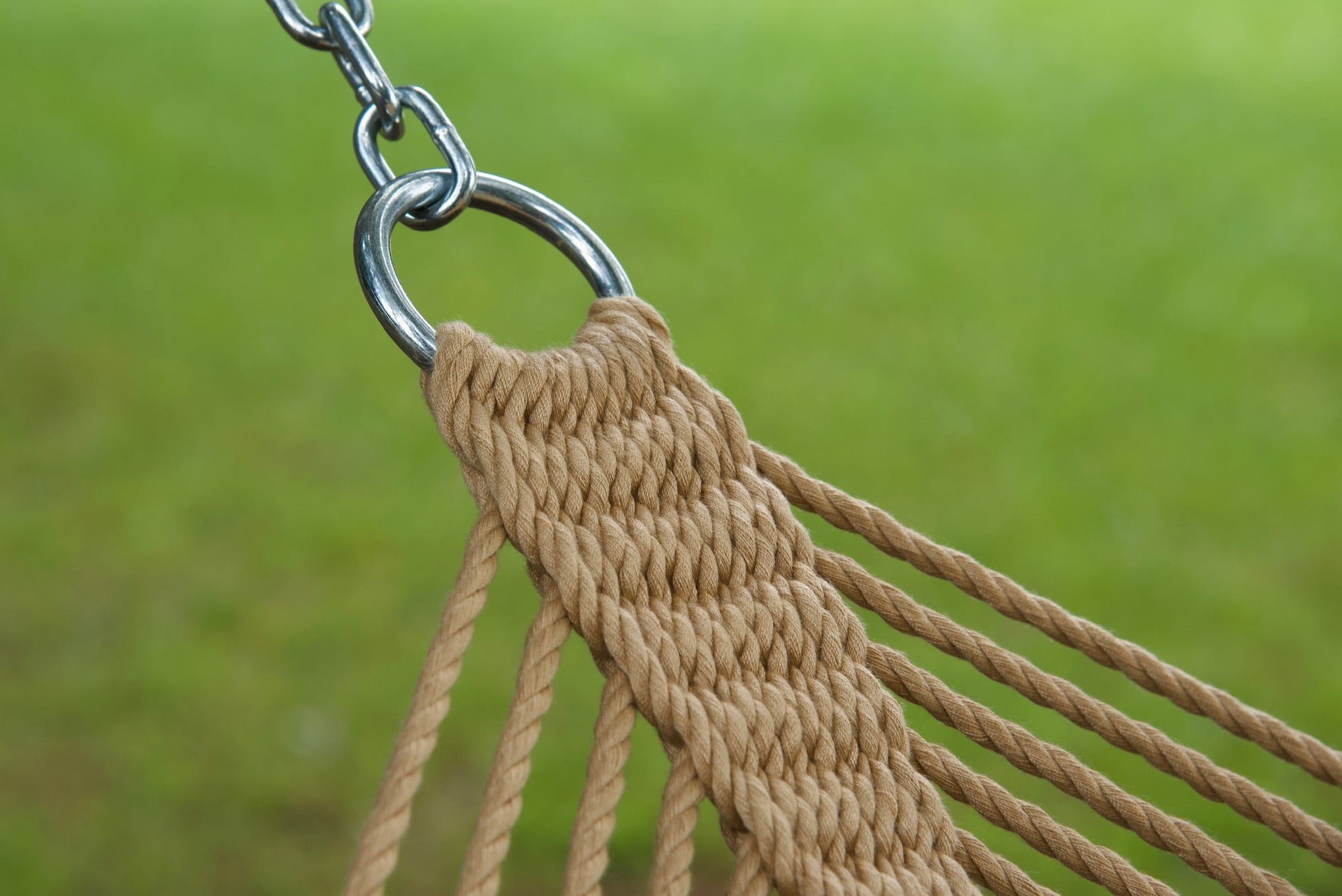 Stainless steel hanging ring, polyester end cords, and clew knot on a tan Island Oasis hammock, lawn behind