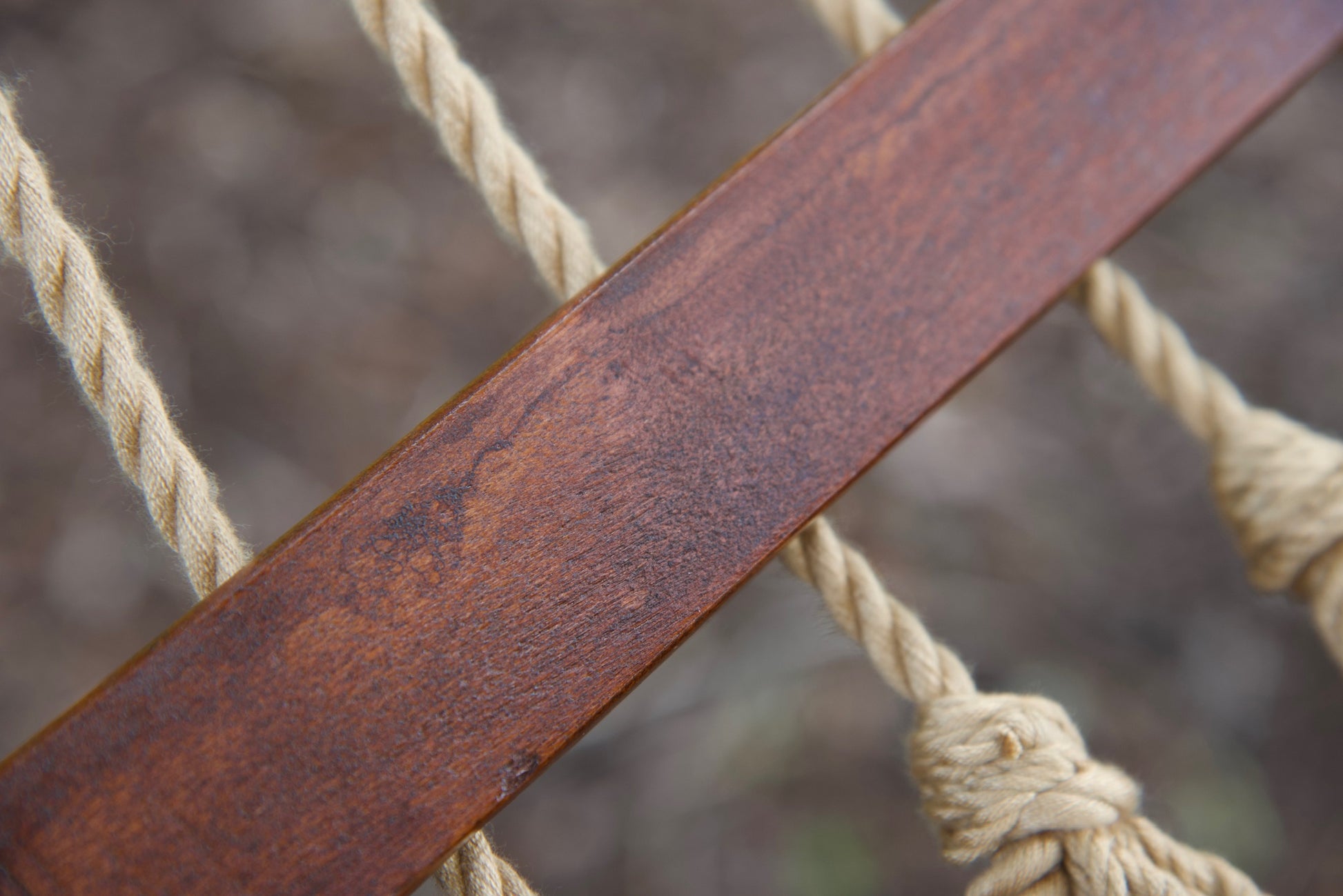 Hardwood spreader bar on a tan Island Oasis hammock with knotted polyester cord ends