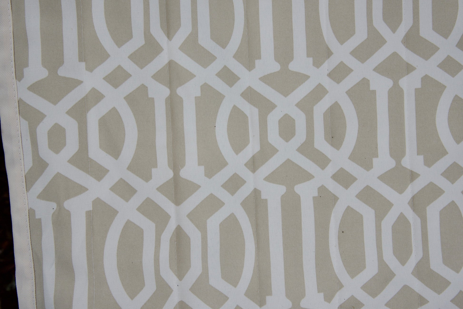 Close-up of the beige pattern Jacquard-woven polyester bed on an Island Tranquility hammock, white trellis print