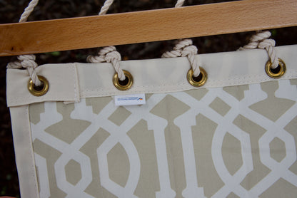 Caribbean Hammocks label and brass roll-rimmed grommets on the reinforced edge of a beige pattern Island Tranquility hammock