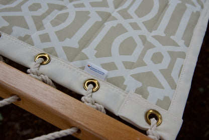 Corner of a beige pattern Island Tranquility hammock showing the reinforced edge, brass grommets and Caribbean Hammocks label