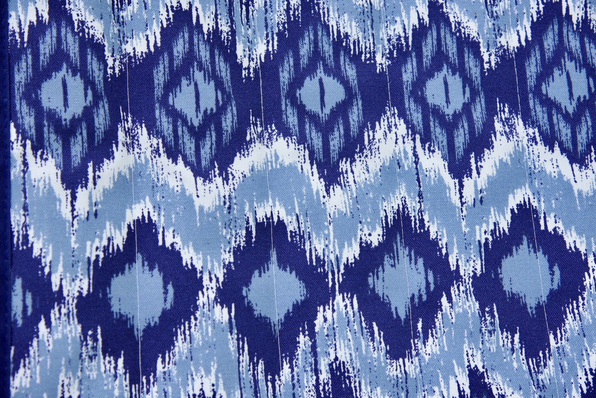 Close-up of the blue wave Jacquard-woven polyester bed on an Island Tranquility hammock, navy and pale blue ikat diamond print