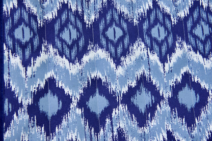 Close-up of the blue wave Jacquard-woven polyester bed on an Island Tranquility hammock, navy and pale blue ikat diamond print