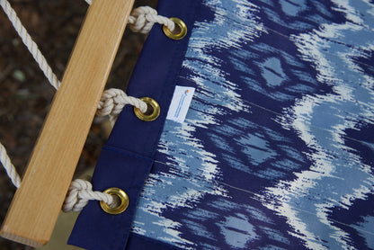 Brass roll-rimmed grommets and polyester end cords on the reinforced edge of a blue wave Island Tranquility hammock