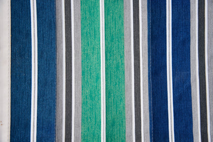 Close-up of the green and blue stripe Jacquard-woven polyester bed on an Island Tranquility hammock, navy, green, grey and white bands