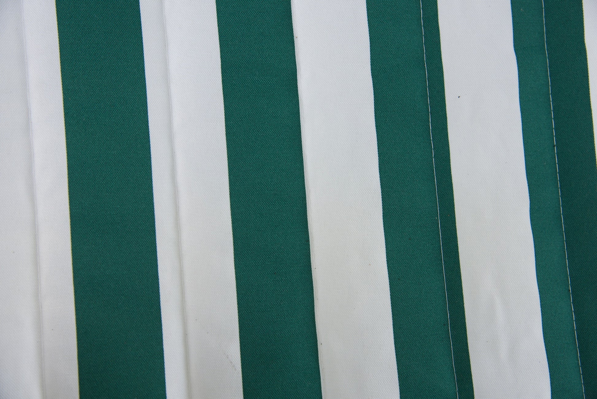 Close-up of the green stripe Jacquard-woven polyester bed on an Island Tranquility hammock, showing lock-stitch quilting