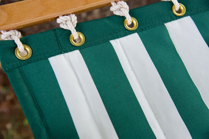 Row of brass roll-rimmed grommets along the reinforced edge of a green stripe Island Tranquility hammock