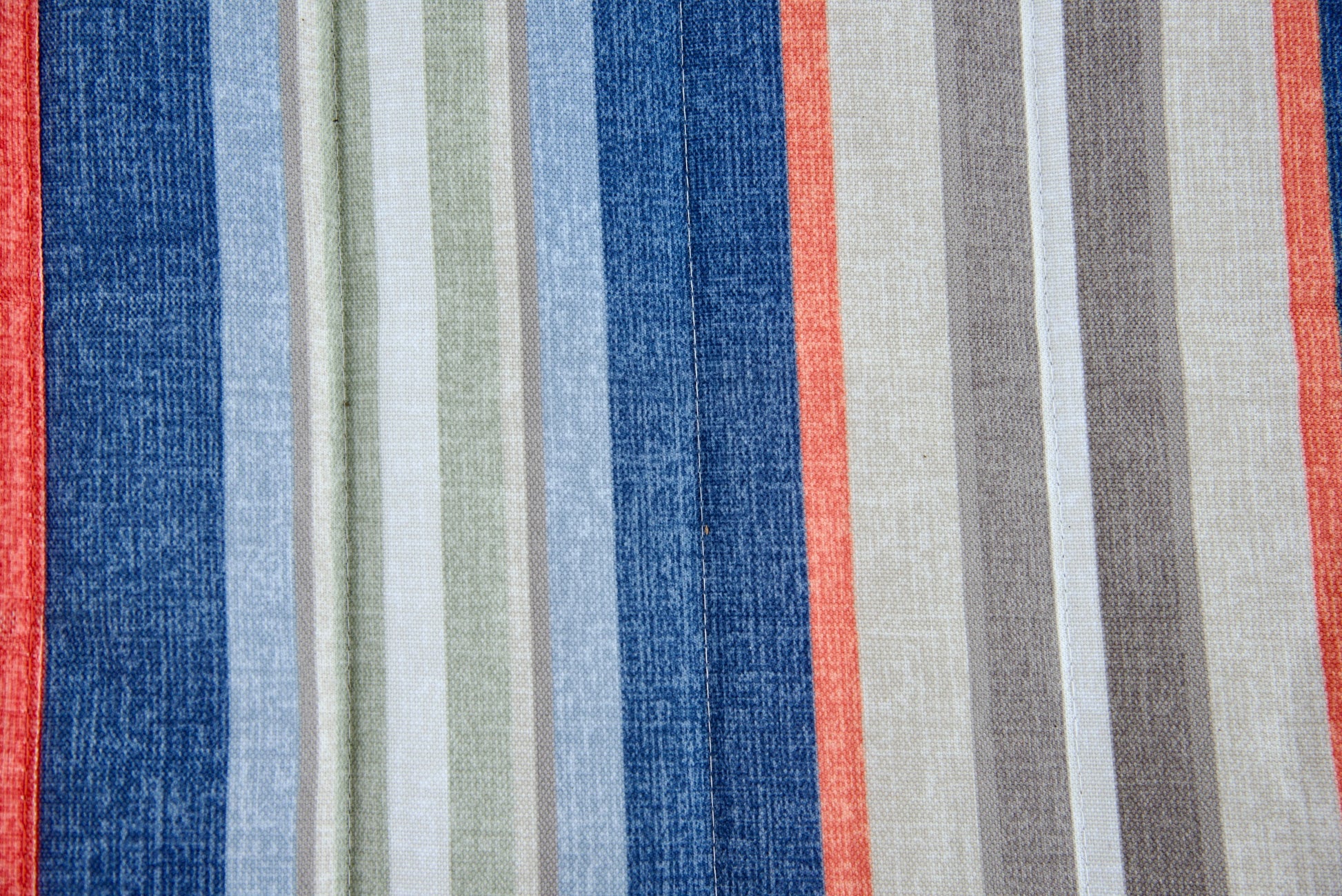 Close-up of the multi Jacquard-woven polyester bed on an Island Tranquility hammock, blue, coral, sage, grey and cream stripes