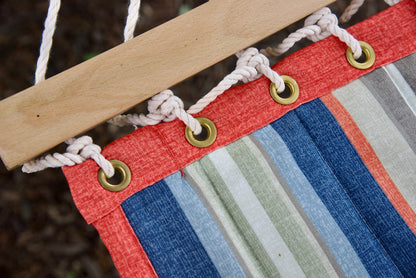 Brass roll-rimmed grommets and polyester end cords on the coral-bound reinforced edge of a multi Island Tranquility hammock