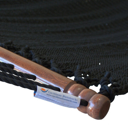 Close-up of the varnished hardwood spreader bar and Caribbean Hammocks label on the Black Jumbo Caribbean Hammock