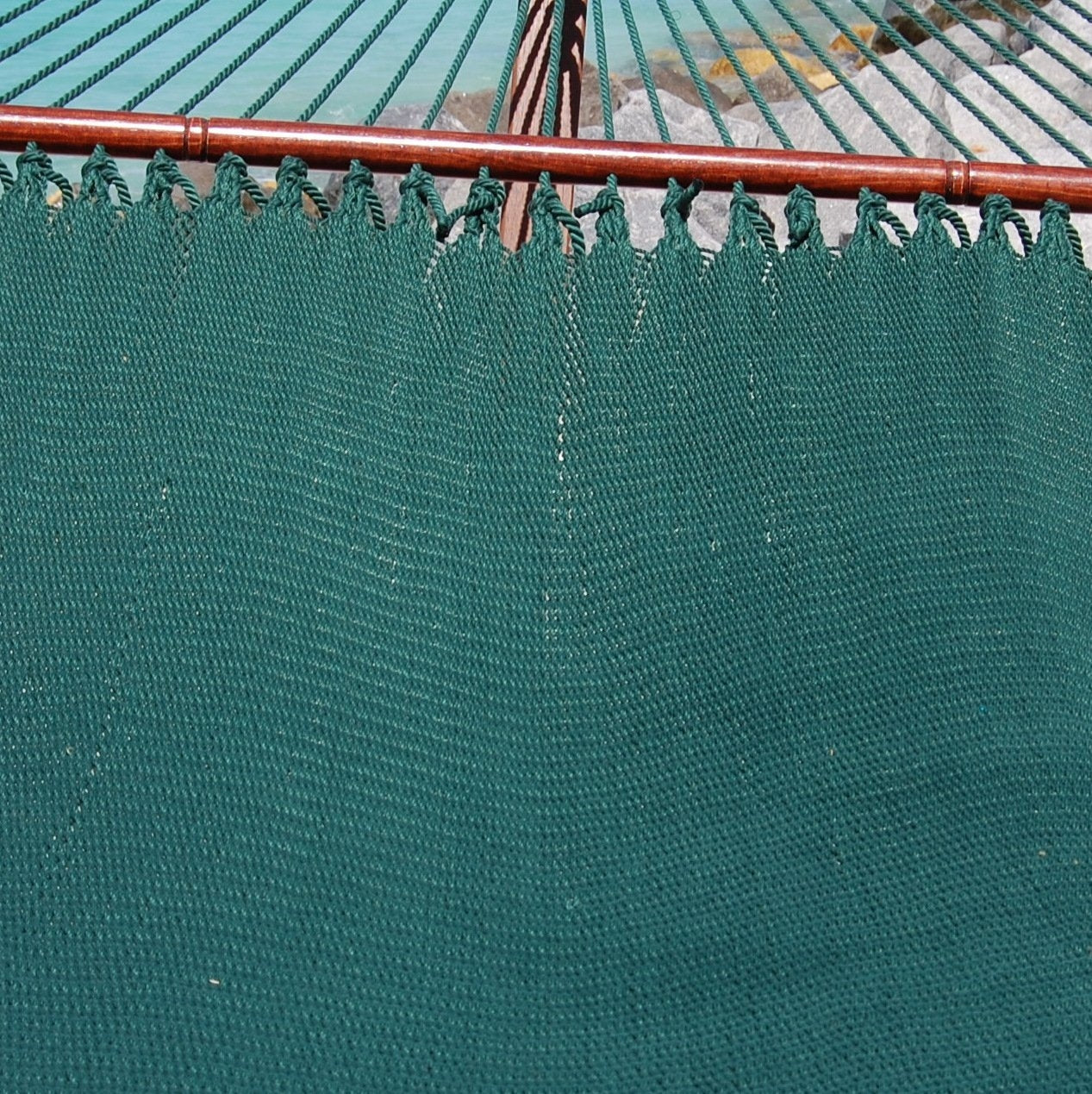 Close-up of the micro-weave bed and hardwood spreader bar of the Green Jumbo Caribbean Hammock