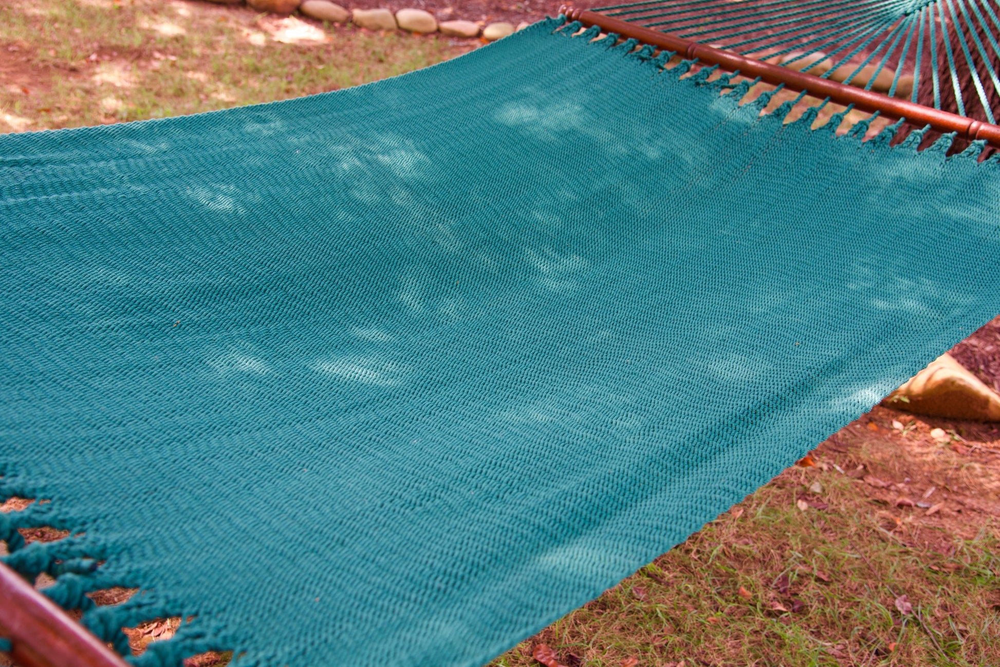 The full hand-woven bed of the Green Jumbo Caribbean Hammock seen end to end