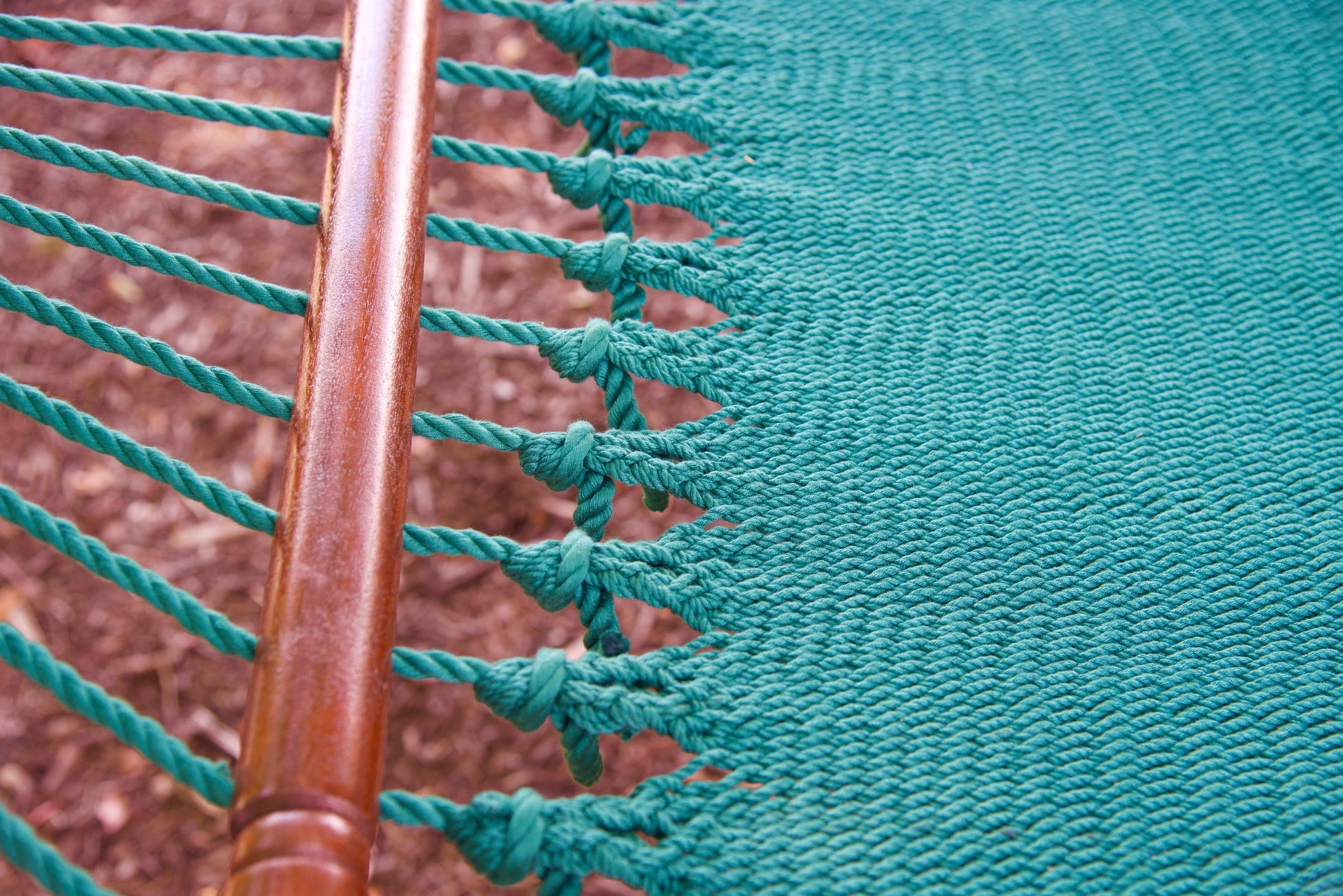 Macro view of the knotted edge loops at the spreader bar of the Green Jumbo Caribbean Hammock