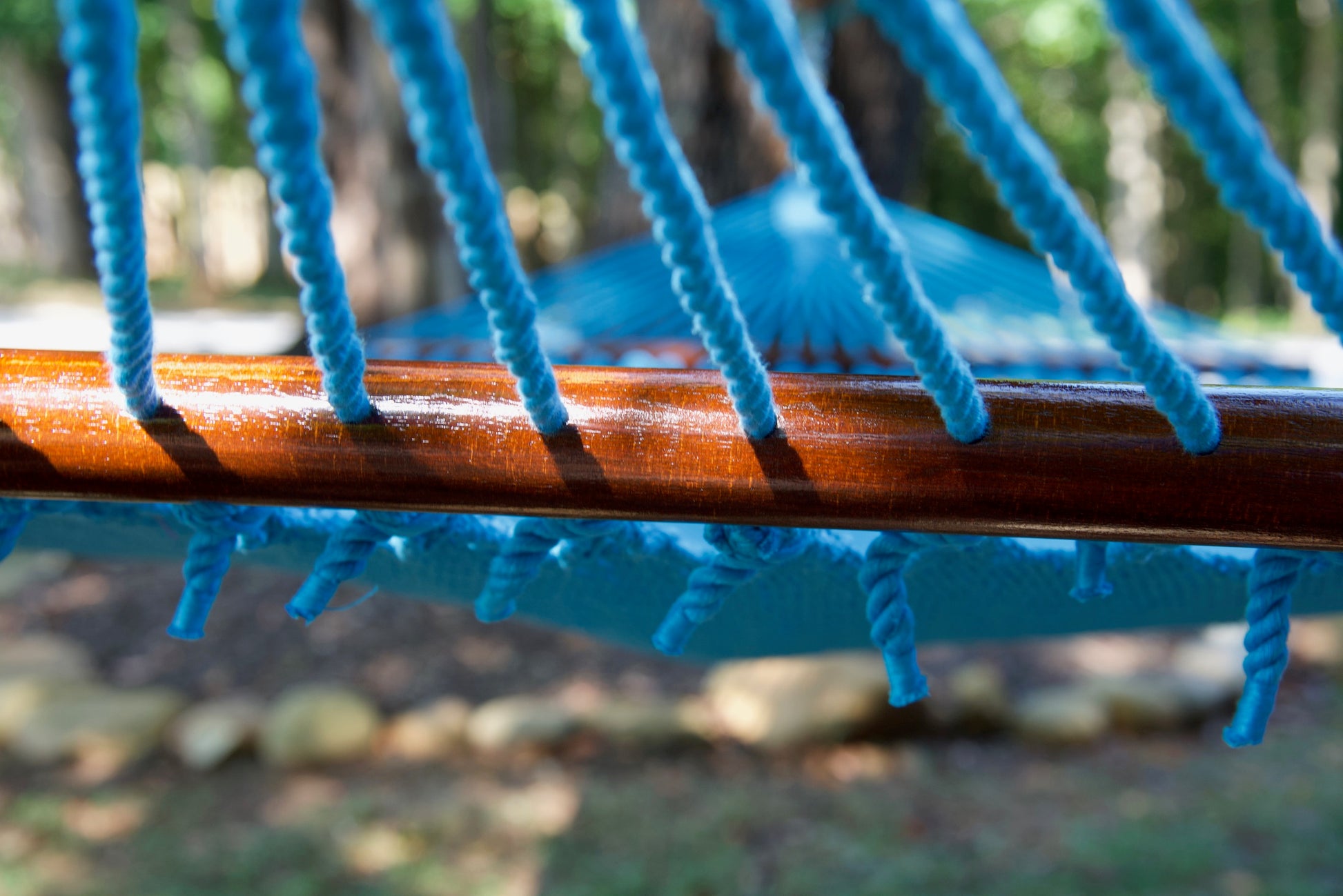 End cords threaded through the drilled hardwood spreader bar of the Light Blue Jumbo Caribbean Hammock