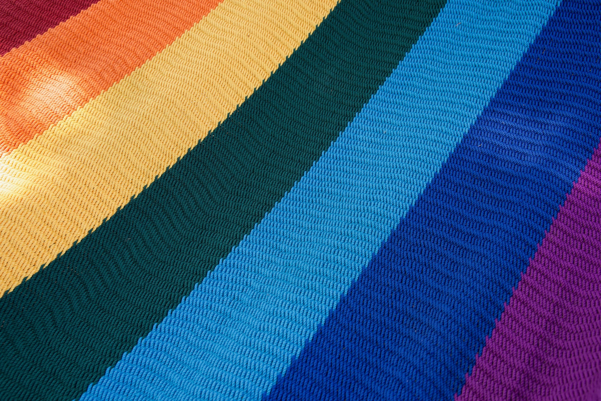 Close-up of the multicolored micro-weave polyester bed of the Rainbow Jumbo Caribbean Hammock