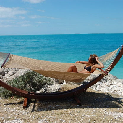 Tan Jumbo Caribbean Hammock on the Wood Arc Hammock Stand overlooking the water