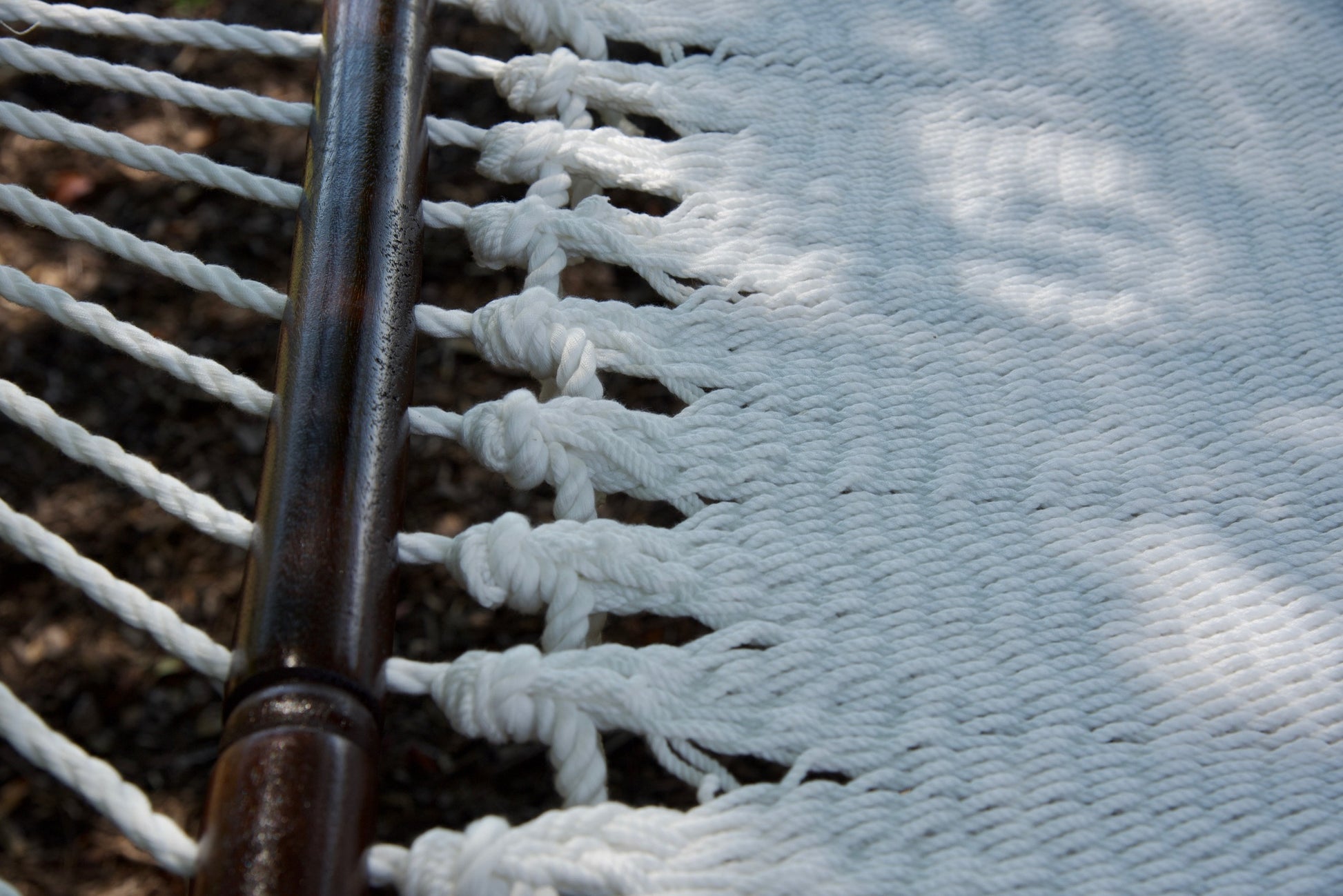 Macro view of the knotted edge loops at the spreader bar of the White Jumbo Caribbean Hammock