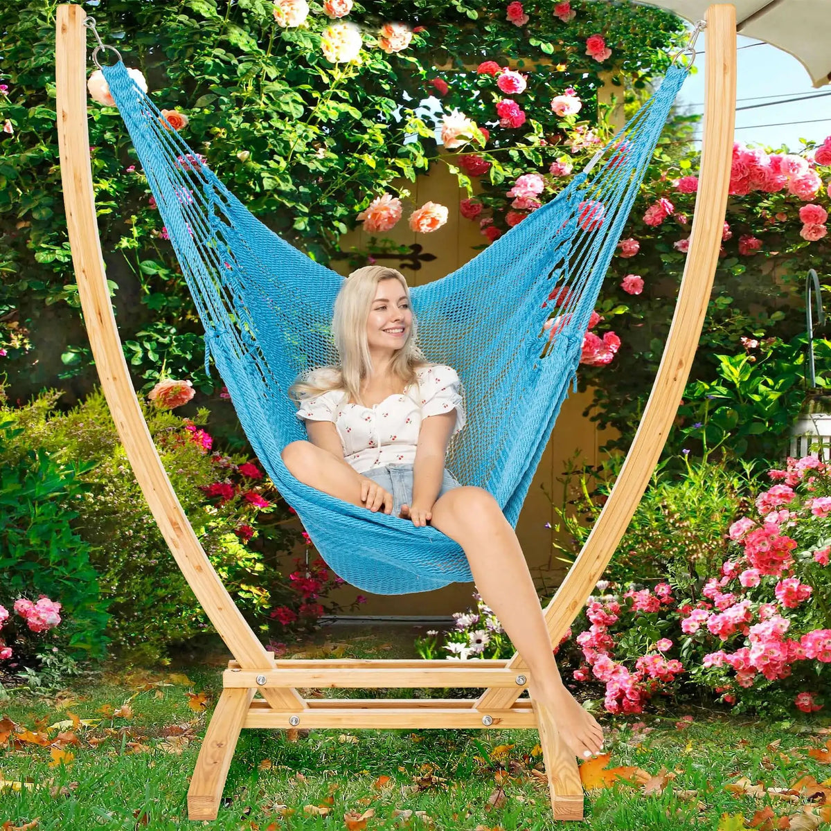 Light Blue Jumbo Caribbean Recliner on a wood arc stand in a garden framed by climbing roses