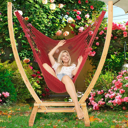 Red Jumbo Caribbean Recliner on a wood arc stand in a garden framed by climbing roses