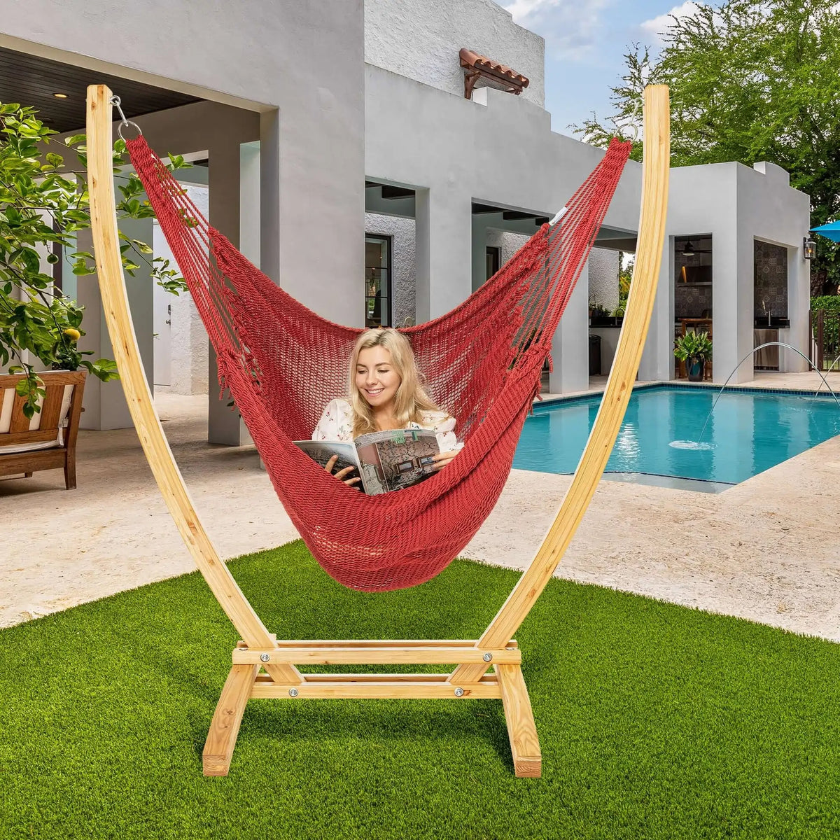 Red Jumbo Caribbean Recliner on a wood arc stand beside a swimming pool