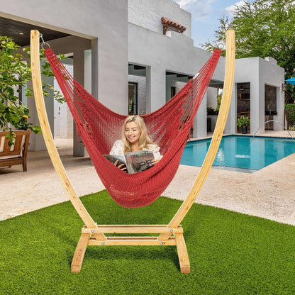 Red Jumbo Caribbean Recliner on a wood arc stand beside a swimming pool