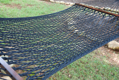 Close view of the Black polyester rope bed and wood spreader bar of the Jumbo Rope Hammock.
