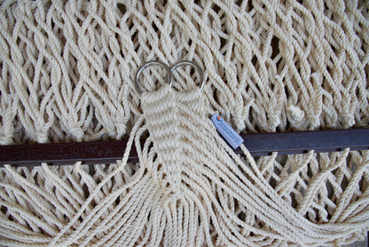 Close view of the gathered Cream end cords and O-rings of the Jumbo Rope Hammock above the wood spreader bar.