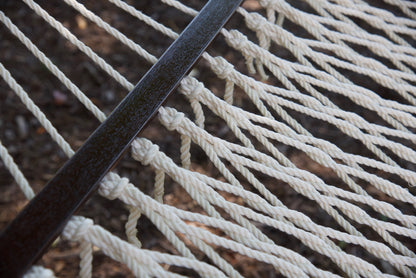 Close view of the varnished wood spreader bar and Cream polyester rope of the Jumbo Rope Hammock.