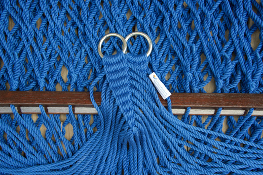 Close view of the gathered Dark Blue end cords and O-rings of the Jumbo Rope Hammock above the wood spreader bar.
