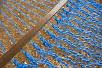 Close view of the varnished wood spreader bar and Dark Blue polyester rope of the Jumbo Rope Hammock.