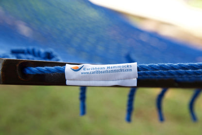 Caribbean Hammocks brand label on the wood spreader bar of the Dark Blue Jumbo Rope Hammock.
