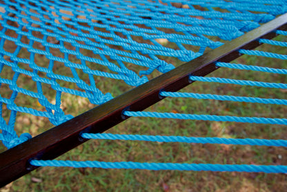 Close view of the varnished wood spreader bar and Light Blue polyester rope of the Jumbo Rope Hammock.