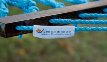 Caribbean Hammocks brand label on the wood spreader bar of the Light Blue Jumbo Rope Hammock.