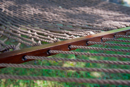 Close view of the Mocha end cords threaded through the wood spreader bar of the Jumbo Rope Hammock.