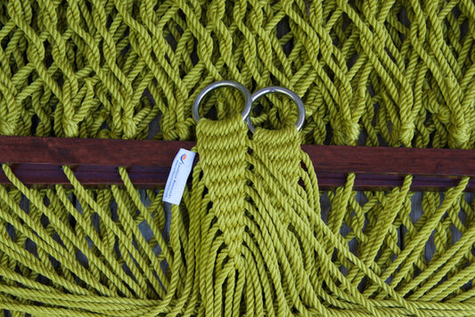 Close view of the gathered Olive end cords and O-rings of the Jumbo Rope Hammock above the wood spreader bar.
