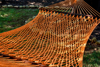Close view of the Orange polyester rope bed and wood spreader bar of the Jumbo Rope Hammock.