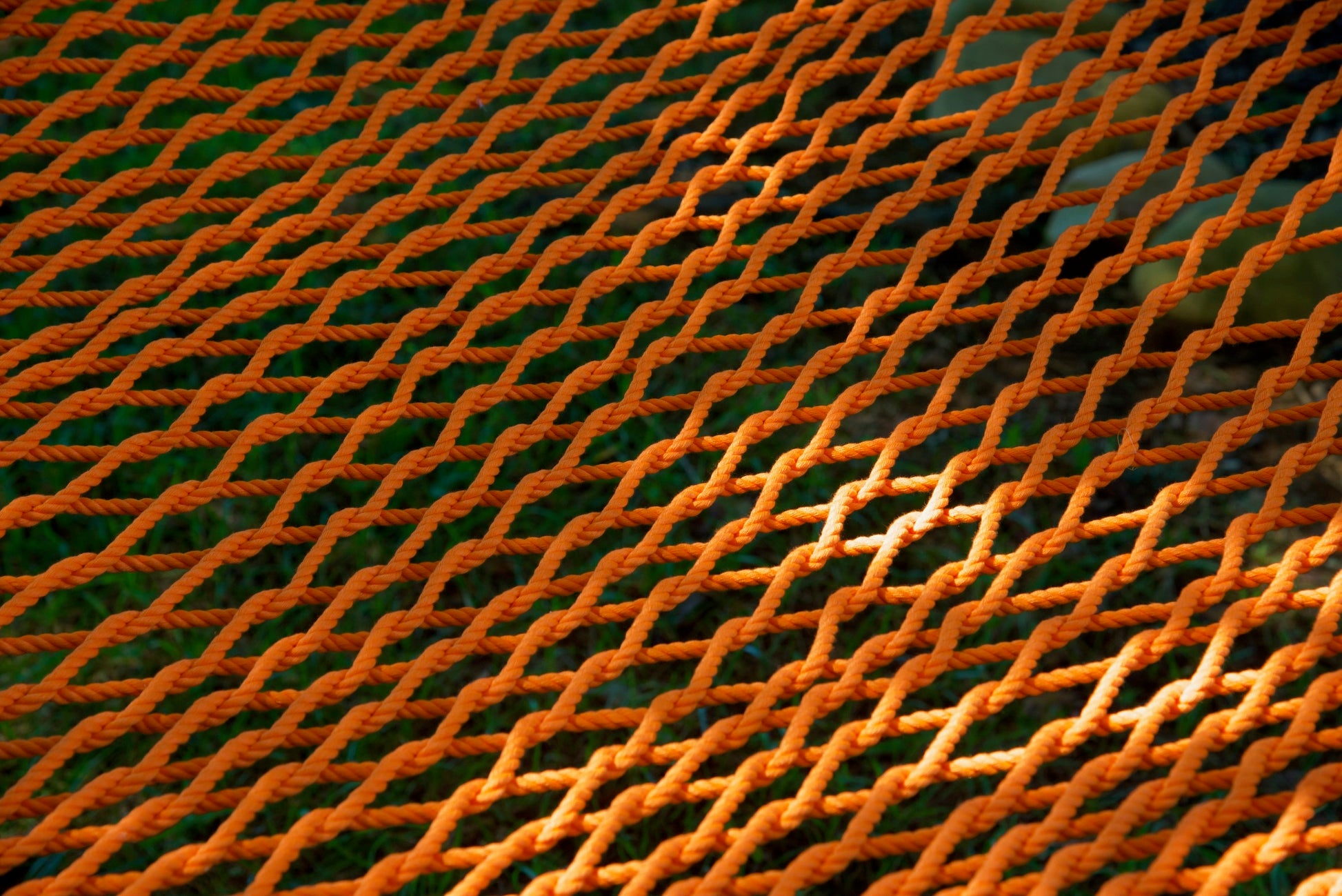 Close view of the hand-woven Orange soft-spun polyester rope weave of the Jumbo Rope Hammock.